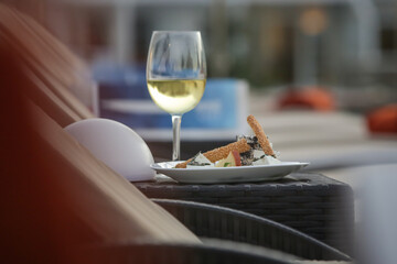 Simply  hand-picked cheese platter of artisan cheeses fruit and nuts with a glass of white wine