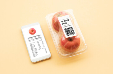 Nutrition information of organic fruit with apple in packaging and data from qr code on smart phone.food and healthy concepts