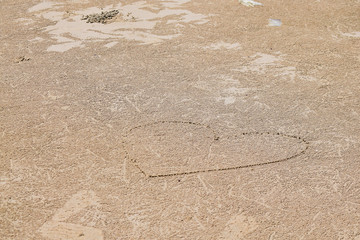 Heart drawn on beach sand