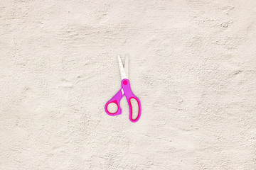 Pink scissors on the table 