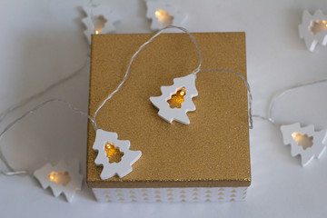 box with christmas present and wooden garland