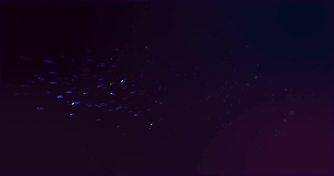 Sci-Fi backdrop with clouds particles system in dark purple liquid. Bright polygonal particles as asteroids and meteor flows. Gradient background with rainbow dust moving after explosion.