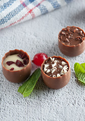 chocolates with different toppings and with mint and berries	