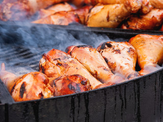 Grilled chicken legs. Outdoor barbecue. Fast food BBQ.