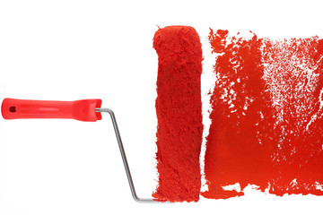 red paint roller leaving a smear of red paint on a white sheet. white background