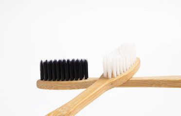Bamboo toothbrush with black and white brush isolated on white background