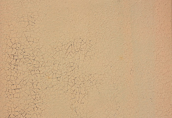 Wall with cracked yellow paint. Abstract texture, background