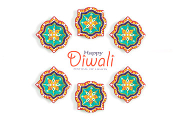Happy Diwali - Clay Diya lamps lit during Dipavali, Hindu festival of lights celebration. Colorful traditional oil lamp diya on white background. Copy space for text.