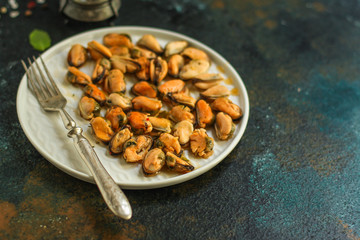 mussels in oil and spices (appetizer mollusks, pickled seafood, healthy food) menu concept. food background. copy space. Top view