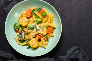 pasta salad, vegetables, mix leaves (tomato, onion, lettuce, chard, arugula and more italian ) menu concept. food background. copy space. Top view