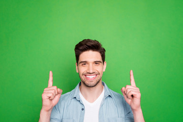Photo of amazing guy indicating fingers up to empty space advising cool low shopping prices wear...