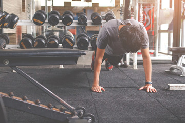 Sport man doing push ups exercise in gym. Workout concept. Fitness concept