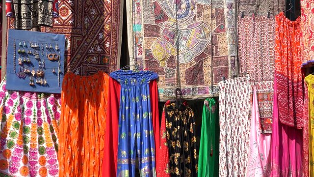 Assortment of colorful clothes for sale in local street market in Udaipur, Rajasthan, India. Close up