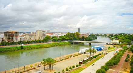 Guadalquivir river and skyline of modern Los Remedios neighborhood in Seville, Andalusia, Spain