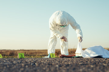 Criminological expert collecting evidence at the crime scene.