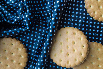 Round cookie on black fabric background
