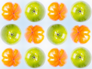 Pattern with apples and persimmons on a light background