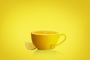 Cup of tea with lemon slice on yellow background. blank label