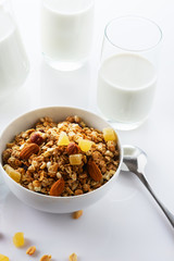 Health food. Muesli with milk and the baked apple. High key. Close up. Selective focus.