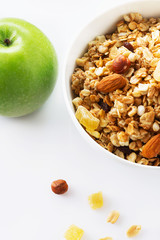Health food. Muesli with milk and the baked apple. High key. Close up. Selective focus.