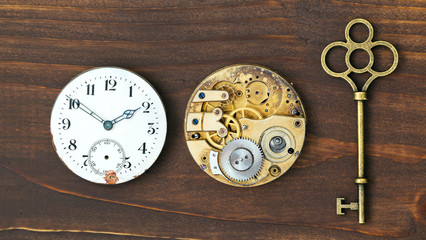Vintage key, clock face and watch mechanism, escape room concept