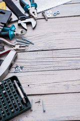 Hand tools on wooden background