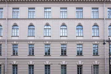 Vintage architecture classical light brown pink facade with arch windows front view