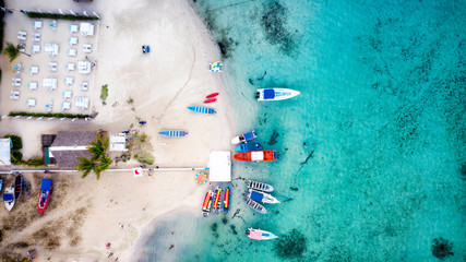 Dominican republic beach with crystal clear sea and sport boats. Colorful aerial photo by drone...
