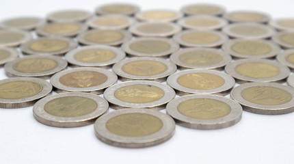 Close up Many Thai coins arranged in a white background. Conceptual interpretation of means to expand Whether saving money or investing For the growth to grow even more For stability in the future