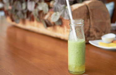 smoothie made of vegetables in glass bottle on wooden table