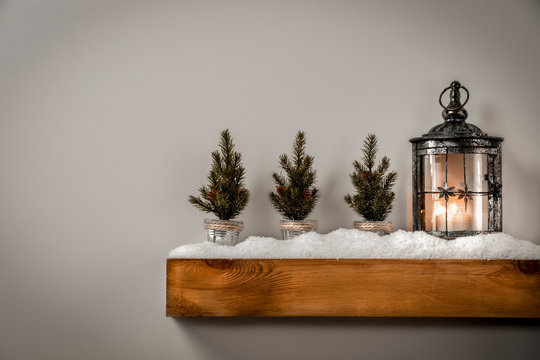 Christmas Decorations In Bright Shiny Colors With Christmas Lights, Picture Frames And Blurred White Wall Background.