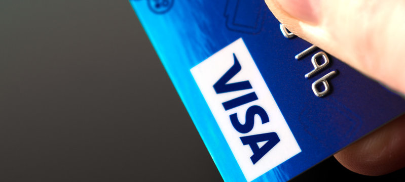 Plastic card VISA in hand. Selective focus