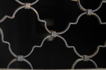 Fototapeta na wymiar Forged metal lattice on a black background.