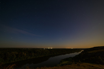 Stars in the night sky over the river. Photographed with a long exposure.