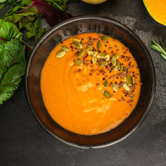 pumpkin or carrot cream soup (first course, healthy food, diet) menu concept. food background. copy...