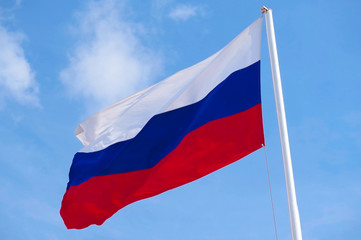 Fototapeta na wymiar Russian flag waving in the wind over blue sky