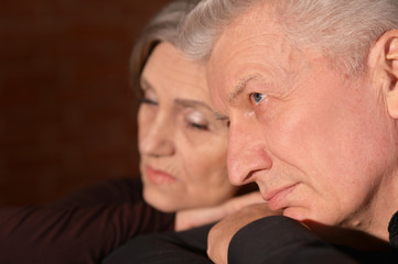 Close up portrait of sad senior couple
