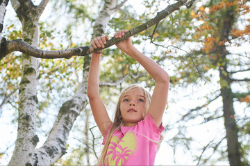 Child brave cute girl climbing on tree