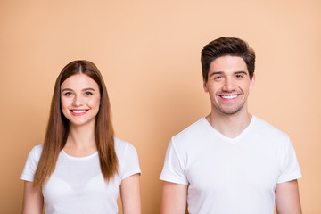 Close-up portrait of his he her she nice attractive lovely cheerful cheery content couple coworkers colleagues wearing white t-shirt isolated over beige pastel color background