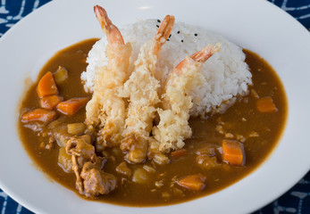 Japanese curry with fried shrimps on rice.