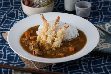 Japanese curry with fried shrimps on rice.
