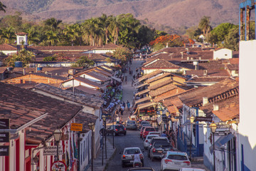 Pirenopolis, Goias, Brazil, October 17, 2019: Slopes and heavily wooded cobblestone streets with many cars in the historic center of Pirenopolis, with bars, restaurants, craft shops and entertainment.