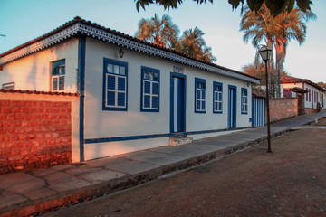 The beautiful design of the facade of a blue and white colonial style house with eaves accents on the leisure street of the historic city of Piren&oacute;polis in central Brazil.