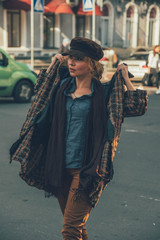 Elder adult caucasian woman on a walk in european street. Autumn retro outfit. Vintage styled and...