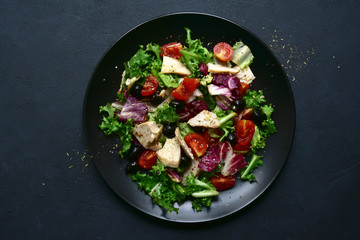 Vegetable salad with chicken and spicy citrus dressing. Top view with copy space.