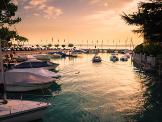 Sunset on the small touristic port of Sirmione, Lake Garda, Italy.