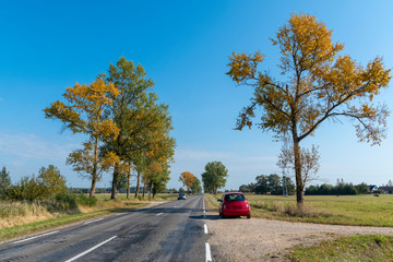 Cars on autumn rural highway, Lithuania