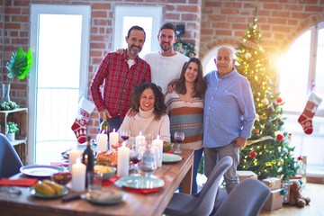 Beautiful family smiling happy and confident. Standing and posing with tree celebrating Christmas at home