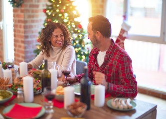 Beautiful family smiling happy and confident. Eating roasted turkey celebrating Christmas at home