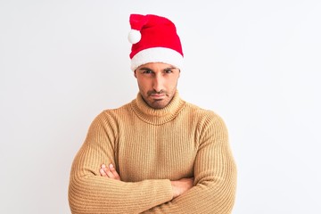 Young handsome man wearing christmas and turtleneck sweater over isolated background skeptic and...